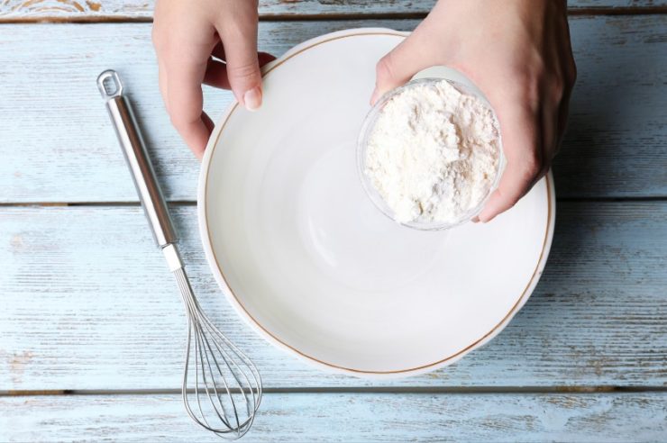 Person Holding Flour and Bowl