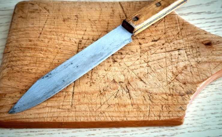 old cutting board  and  a knife 