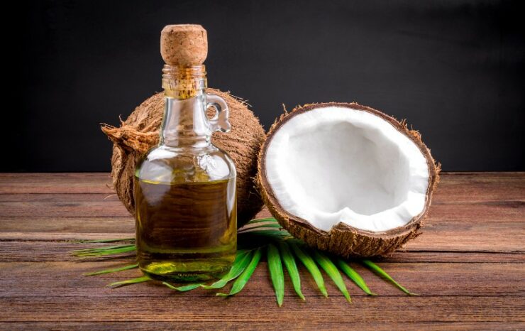 bottle of coconut aminos and coconut next to it