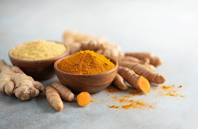 Fresh Turmeric and Ginger Powder in Wooden Bowl