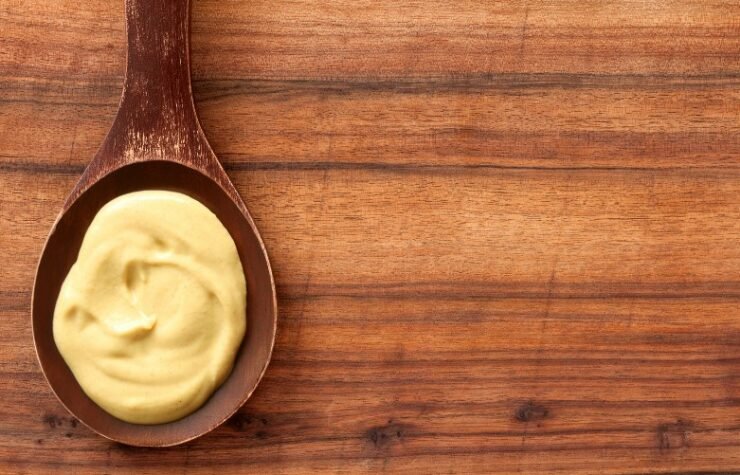 wooden spoon with dijon mustard