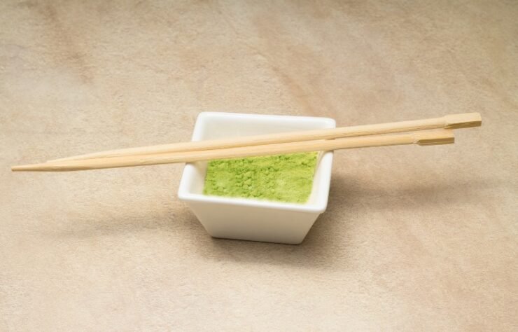 white bowl and chopsticks with wasabi powder